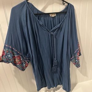 Blue V-neck tie top with statement sleeves